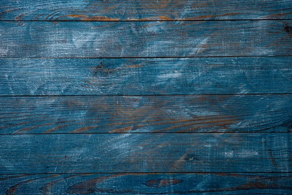 Vintage blue wood background texture with knots and nail holes. Old painted wood wall. Blue abstract background. Vintage wooden dark blue horizontal boards. Front view with copy space. Background for design.