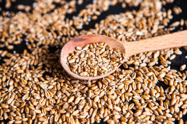 Bowls of various cereals. Various kinds of natural grains and cereals. Different types of groats in bowls on a black background. Healthy nutrition food