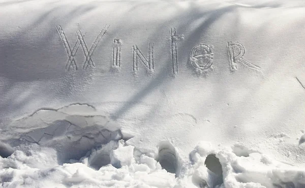 Winter - Snow Writing. Letters written on the snow surface. Frosty and sunny day.