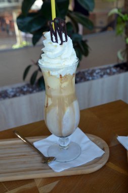 Bir cam bardak krem şanti ile lezzetli buzlu kahve.