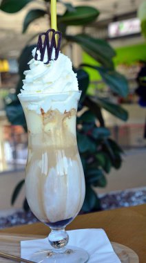 Bir cam bardak krem şanti ile lezzetli buzlu kahve.