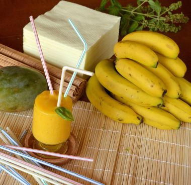 Taze sağlıklı mango ve muz güler yüzlü bir cam. Organik içki.