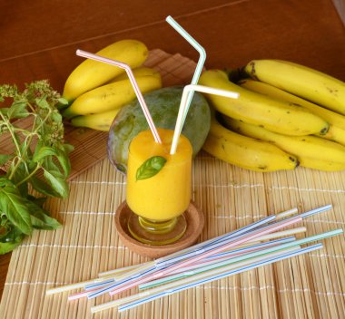 Taze sağlıklı mango ve muz güler yüzlü bir cam. Organik içki.