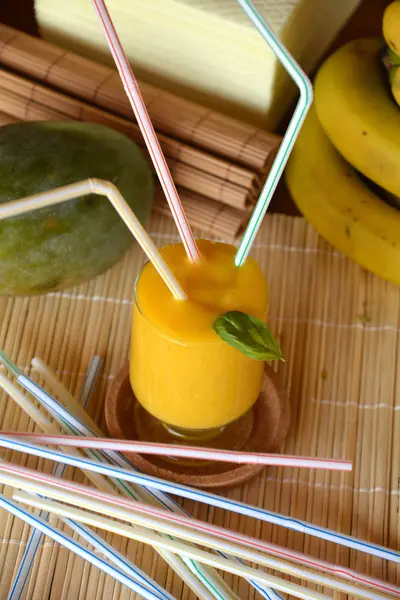 Taze sağlıklı mango ve muz güler yüzlü bir cam. Organik içki.