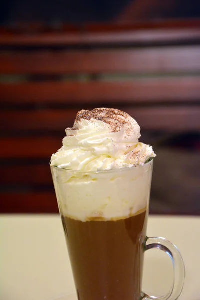 Viennese coffee with whipped cream on glass cup.