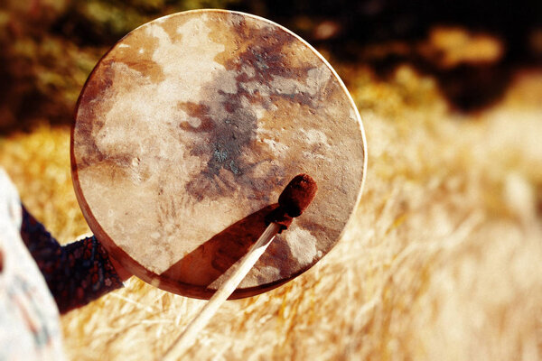 Shaman frame drum in woman hand in the nature
.