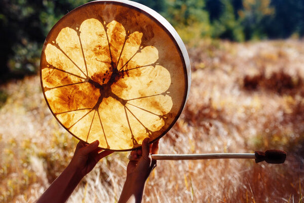 shaman frame drum in woman hand in the nature.