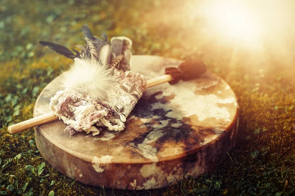 Shamanic drum and shamanic feathers on denim. — Stock Photo, Image