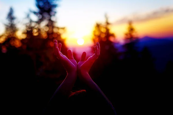 Sun in hands. Sunset on the background of raised hands. — Stock Photo, Image