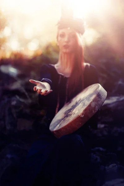 아름다운 샤머니즘 소녀가 자연 속의 샤먼 프레임 드럼 위에서 노는 모습. — 스톡 사진