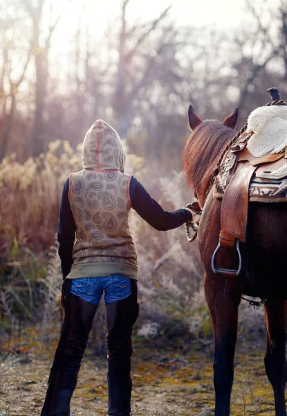Молода красива засмучена дівчина на відкритому повітрі зі своїм конем . — стокове фото