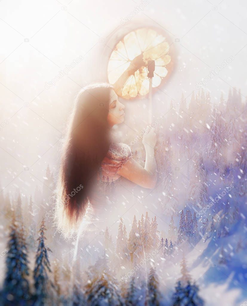 vision of beautiful shamanic girl in snowy mountain landscape.