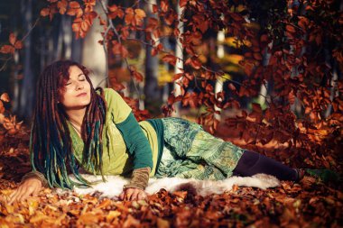 Beautiful woman with long dreadlocks in nature.