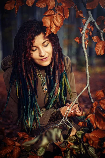 Beautiful girl with radiant red hair in sommer dress in a meditative spiritual gesture of prayer. — Stock Photo, Image