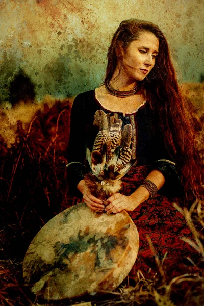 Beautiful shamanic girl playing on shaman frame drum in the nature, old effect. — Stock Photo, Image