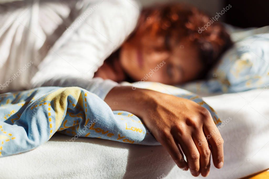 Beautiful sleeping woman in white ornamental clothes.
