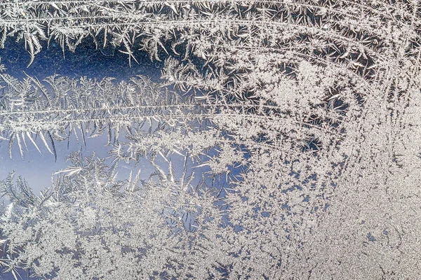 Frosty natural pattern on winter window, ornamental frost on the glass. — Stock Photo, Image