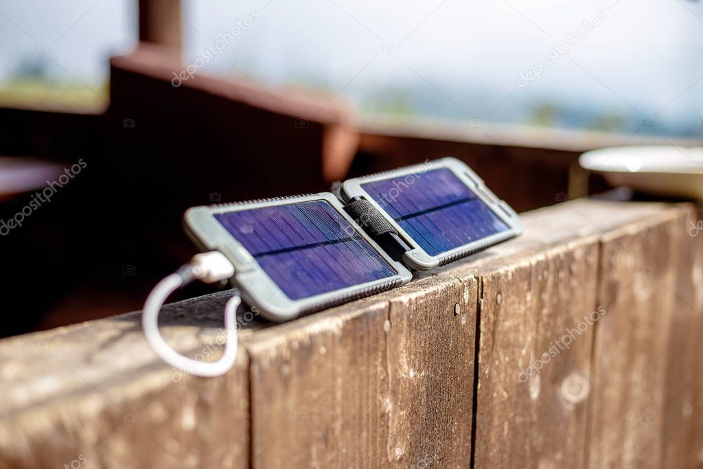 Portable solar panel charges the battery of a powerbank