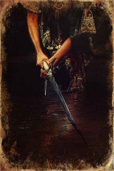 Woman with sword in lake, old photo effect. — Stock Photo, Image