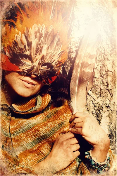 Young woman with a colorful feather face mask, old photo effect. — Stock Photo, Image