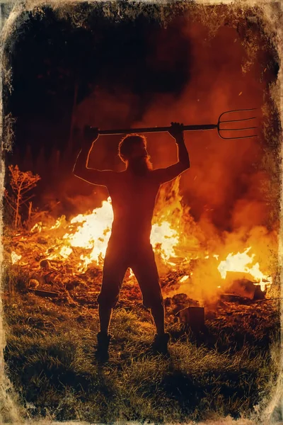 man with pitchfork by the fire, light graphic effect