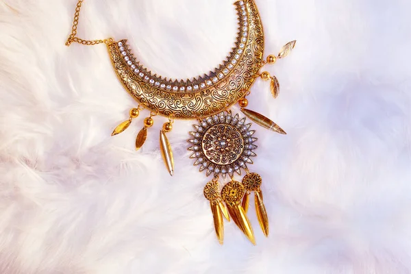 beautiful luxury jewel with filigrane ornaments lying on white fur