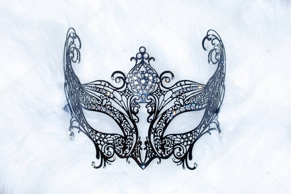 beautiful decorative venice style mask with filigrane linear ornaments on fur background