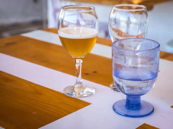 Glasses with cold beer and water on the table — Stock Photo, Image