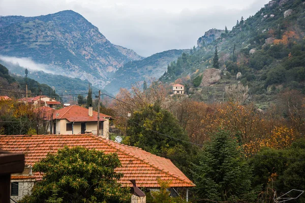 Paisagem de outono nebulosa com casas e montanhas em Vouraikos g — Fotografia de Stock