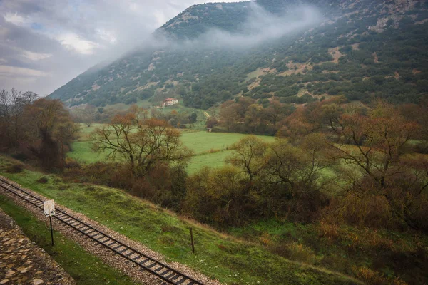 Scenic foggy autumn landscape in Vouraikos gorge near railway, G — Stock Photo, Image