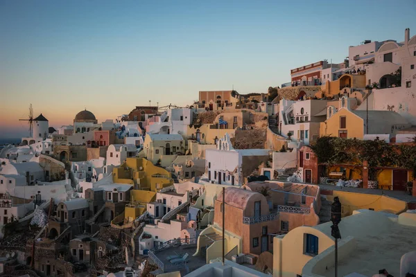 White city on  slope of  hill at sunset, Oia, Santorini