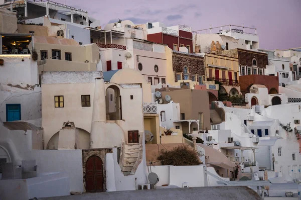 White city on  slope of  hill at sunset, Oia, Santorini