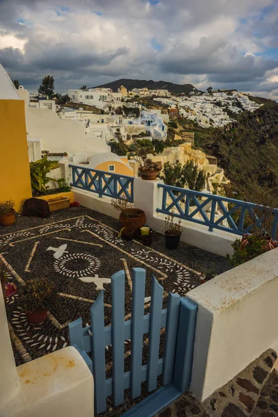 White city on a slope of a hill at sunset, Oia, Santorini, Greec