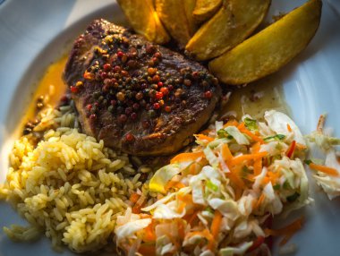 Kızarmış biftek biber soslu patates, pilav ve salata ile