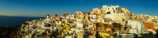 White city on  slope of  hill at sunset, Oia, Santorini