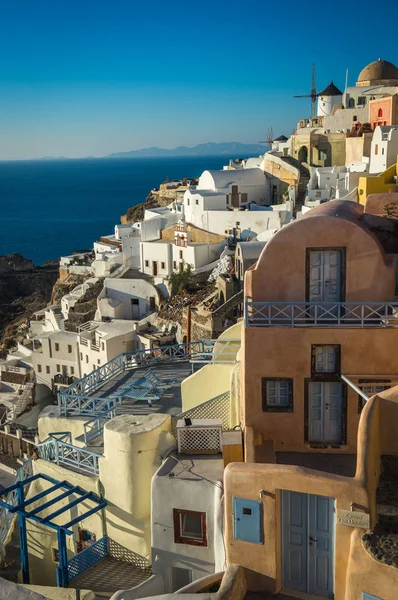 White city on  slope of  hill at sunset, Oia, Santorini