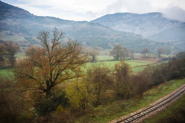 Scenic foggy autumn landscape in Vouraikos gorge near railway, G — Stock Photo, Image