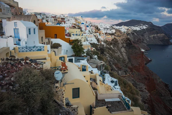 White city on  slope of  hill at sunset, Oia, Santorini