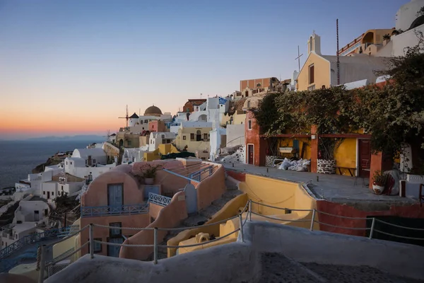 White city on  slope of  hill at sunset, Oia, Santorini