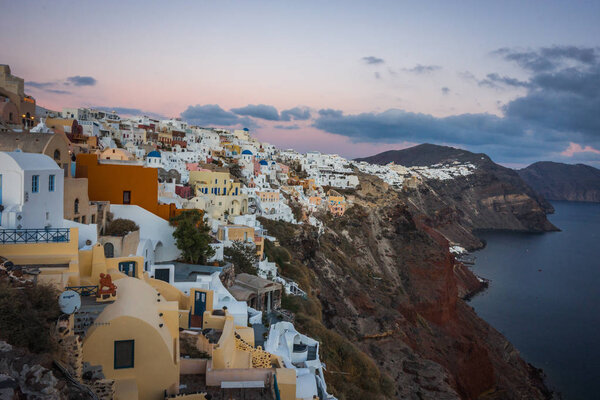 White city on  slope of  hill at sunset, Oia, Santorini