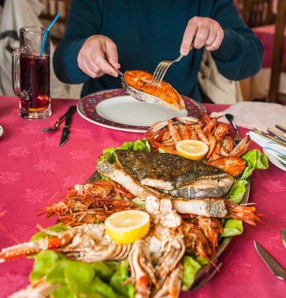 Мужские руки и тарелка морепродуктов — стоковое фото