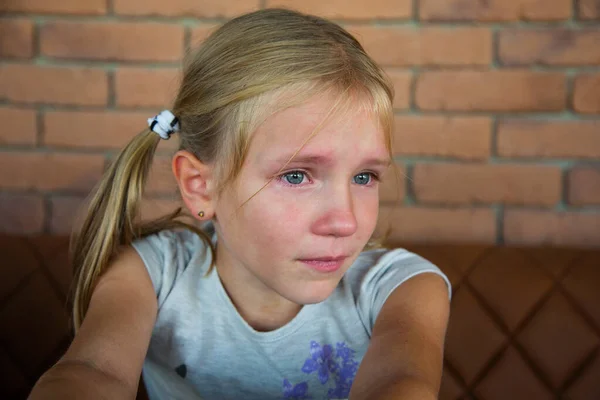 Little blond crying girl with sad expression and tears — Stock Photo, Image