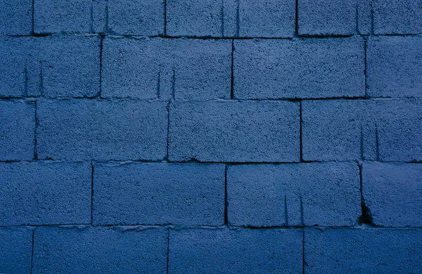 Classic blue color concrete wall stone brick texture background. Concept color of the year 2020