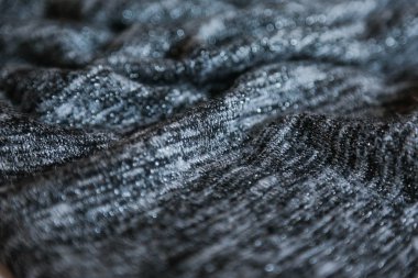  Grey cotton fabric background. Close up gray fabric texture background. wrinkled and shadows, selective focus top view