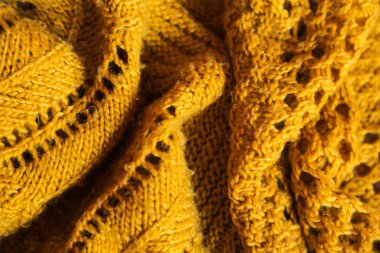Orange knitted background. Close up gray fabric texture background. wrinkled and shadows, selective focus top view