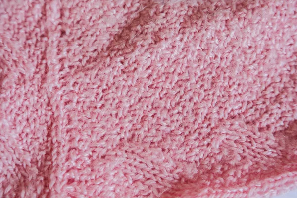 Pink knitted background. Close up gray fabric texture background. wrinkled and shadows, selective focus top view — 스톡 사진