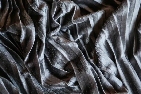 Grey plush velvet background. Close up gray fabric texture background. wrinkled and shadows, selective focus top view — ストック写真