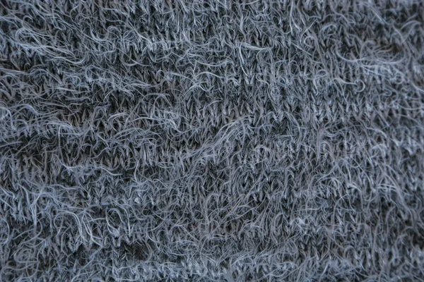 Сірий в'язаний фон. крупним планом сіра текстура тканини фону. зморшкуваті і тіні, вибірковий вид зверху — стокове фото