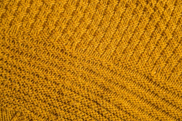 Orange knitted background. Close up gray fabric texture background. wrinkled and shadows, selective focus top view — Stok fotoğraf