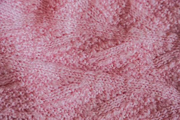 Pink knitted background. Close up gray fabric texture background. wrinkled and shadows, selective focus top view — Stok fotoğraf